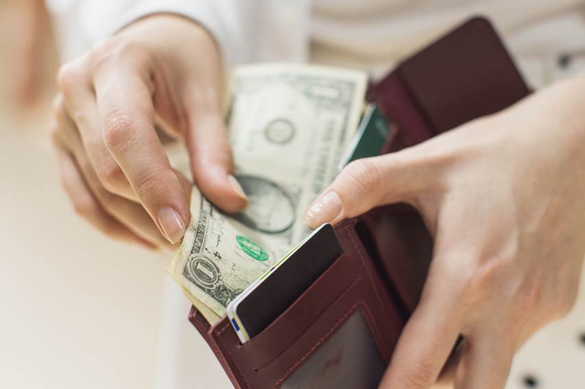 Dollar bills in a wallet